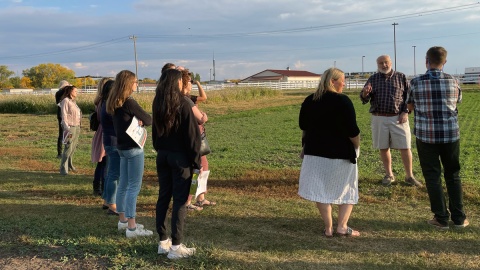 Group standing in agricultural field