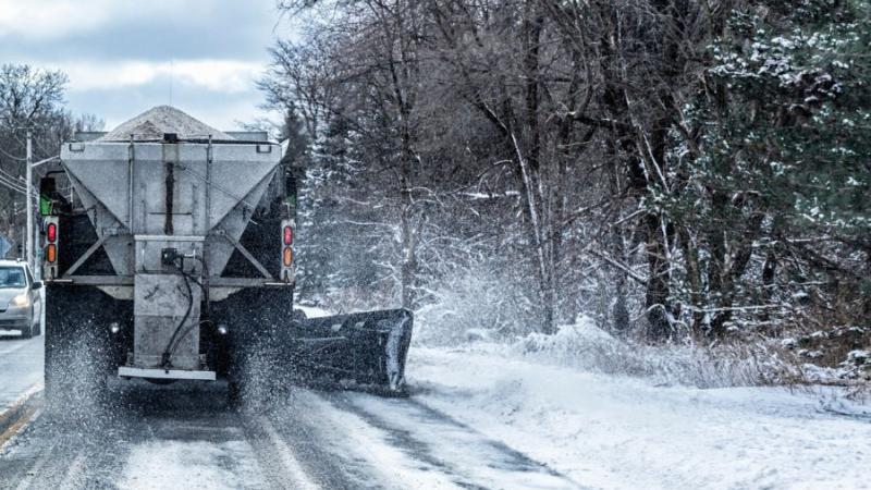 Truck plows a snowy road