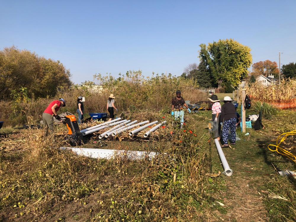 Volunteers building a composting system at The Village Agricultural Cooperative in Rochester