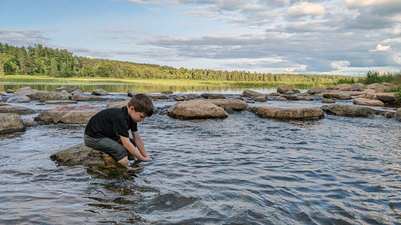 Kid at Lake Itasca, headwaters of the Mississippi River