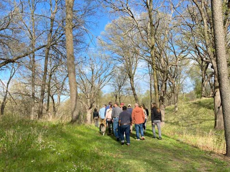 Group of people walk through oak savanna