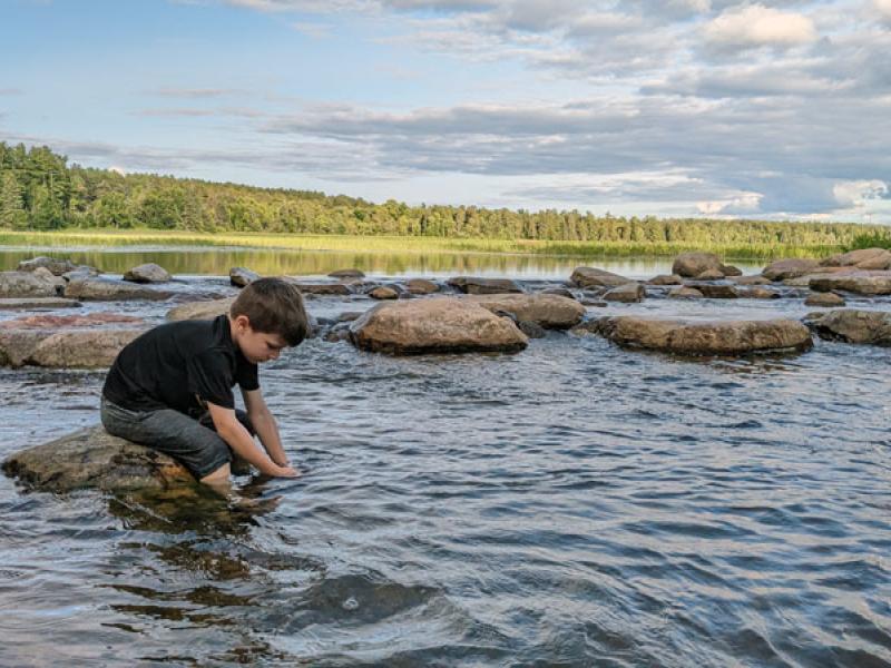 Kid at Lake Itasca, headwaters of the Mississippi River