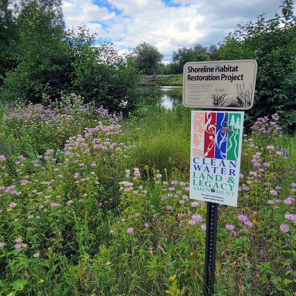 Clean Water Land and Legacy sign by prairie and pond