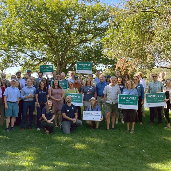 large group of people holding Vote Yes signs